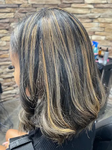 Shoulder-length dark hair with blonde highlights
